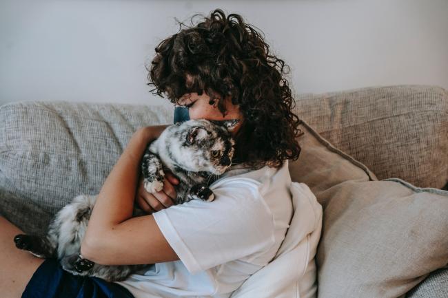 Woman cuddling cat